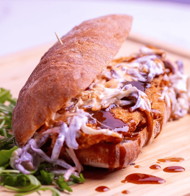 Artisan sandwich on wooden cutting board